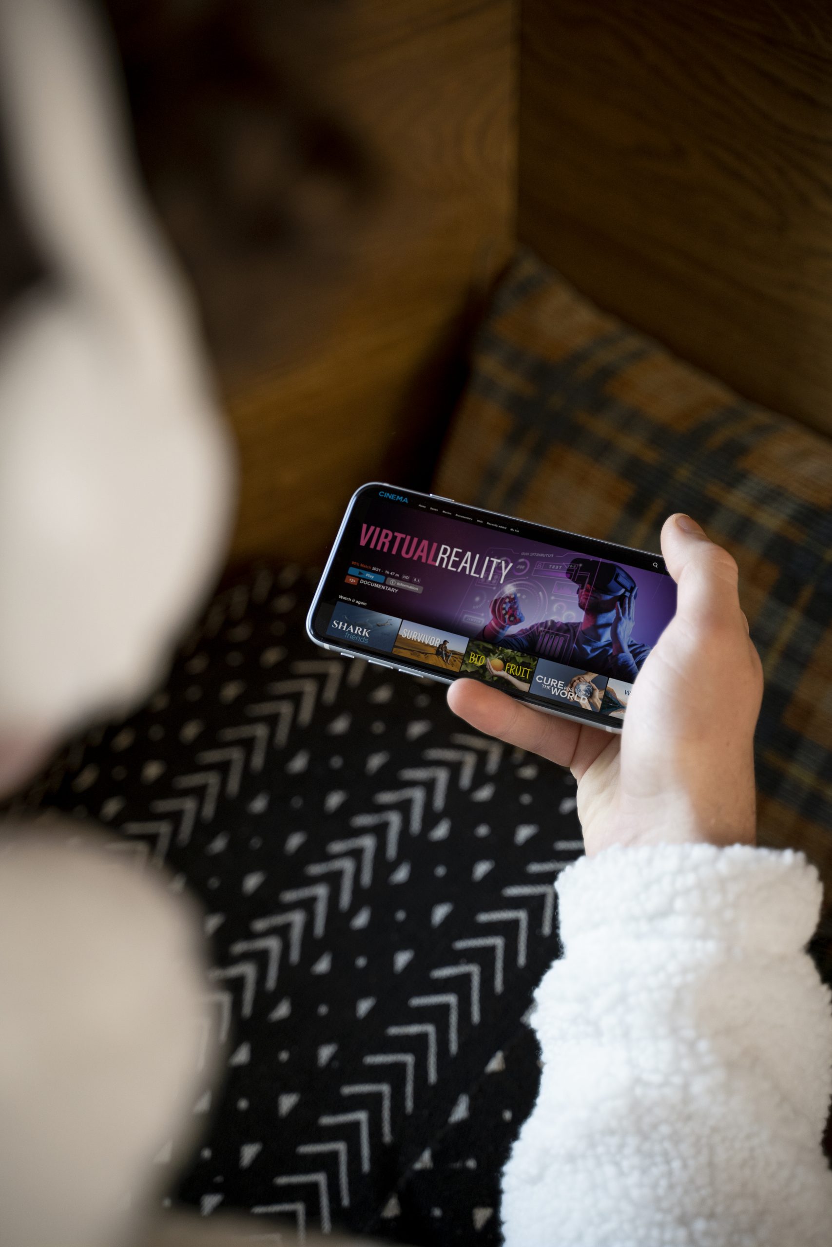 Teenager Sitting His Bed Watching Movie Using His Smartphone Scaled